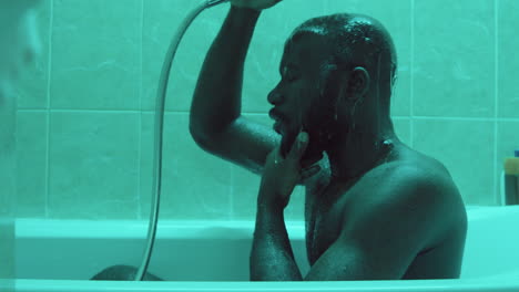 African-American-Man-Showering-in-Bathtub